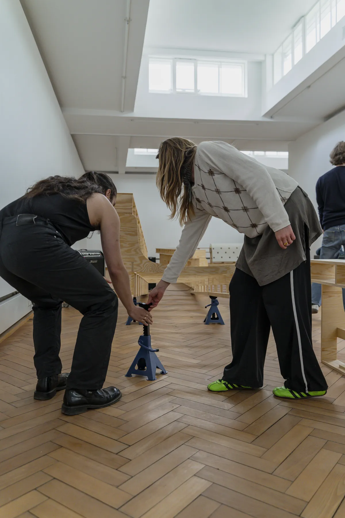 Close-up detail of wooden structural elements and black audio equipment during the installation setup at Trust Trust, Lübeck, 2025.